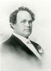 Rev. David Swanson, the first pastor, in a formal portrait wearing a suit and bow tie